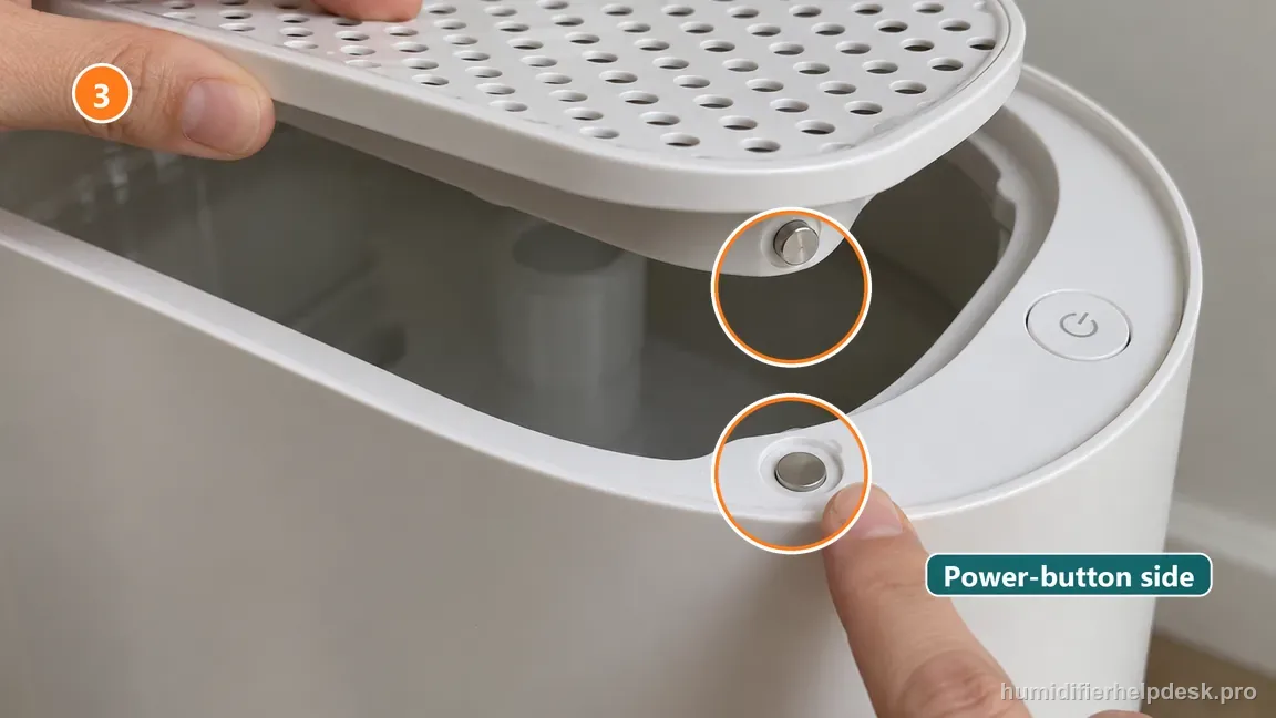 Instructional repair photo: the grate magnet and matching power-button-side seating point are highlighted.