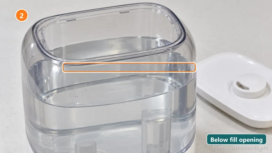 Water is visible inside the translucent humidifier tank below its upper fill limit.